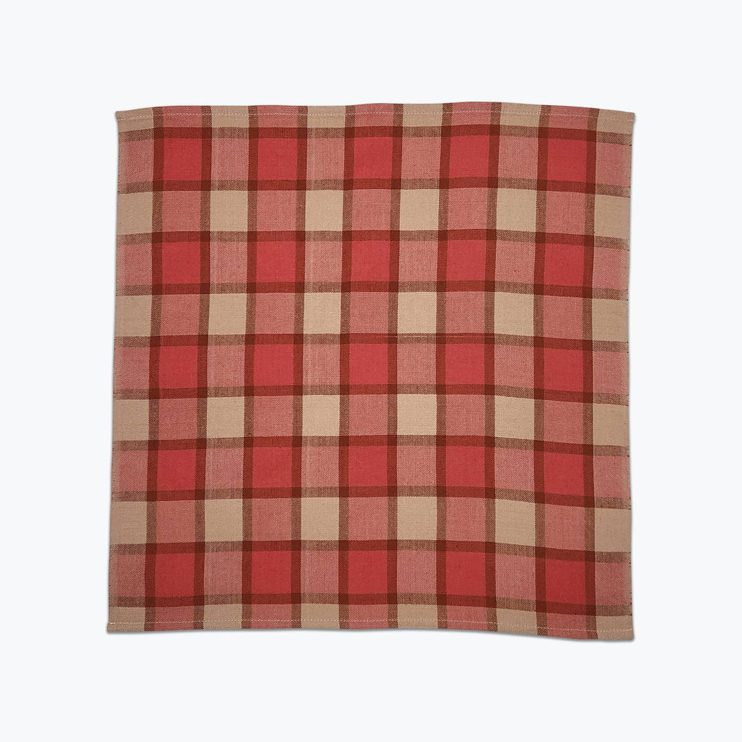 Red and beige plaid fabric on a white background
