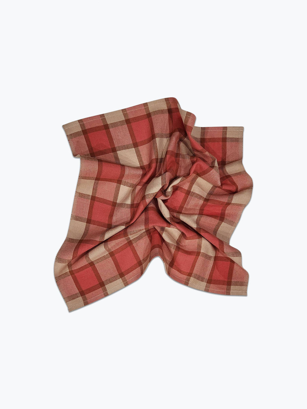Red and beige plaid fabric on a white background